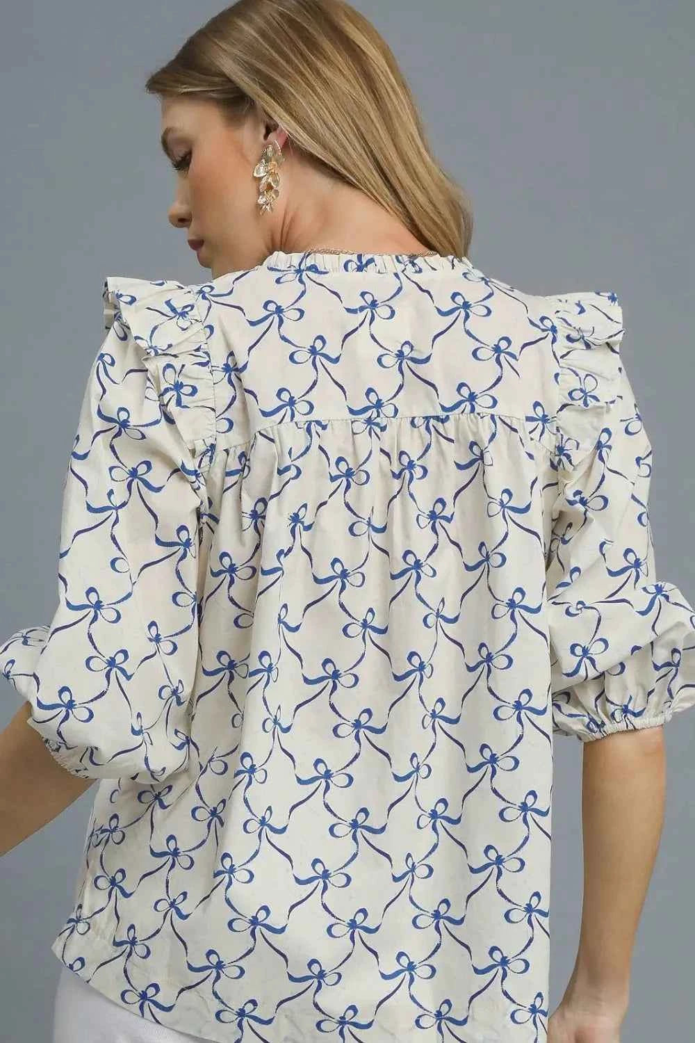 Umgee Ruffled Bow Print Notched Blouse c0354e35-e7af-44d1-b57c-0d30b5868442-Max-Origin