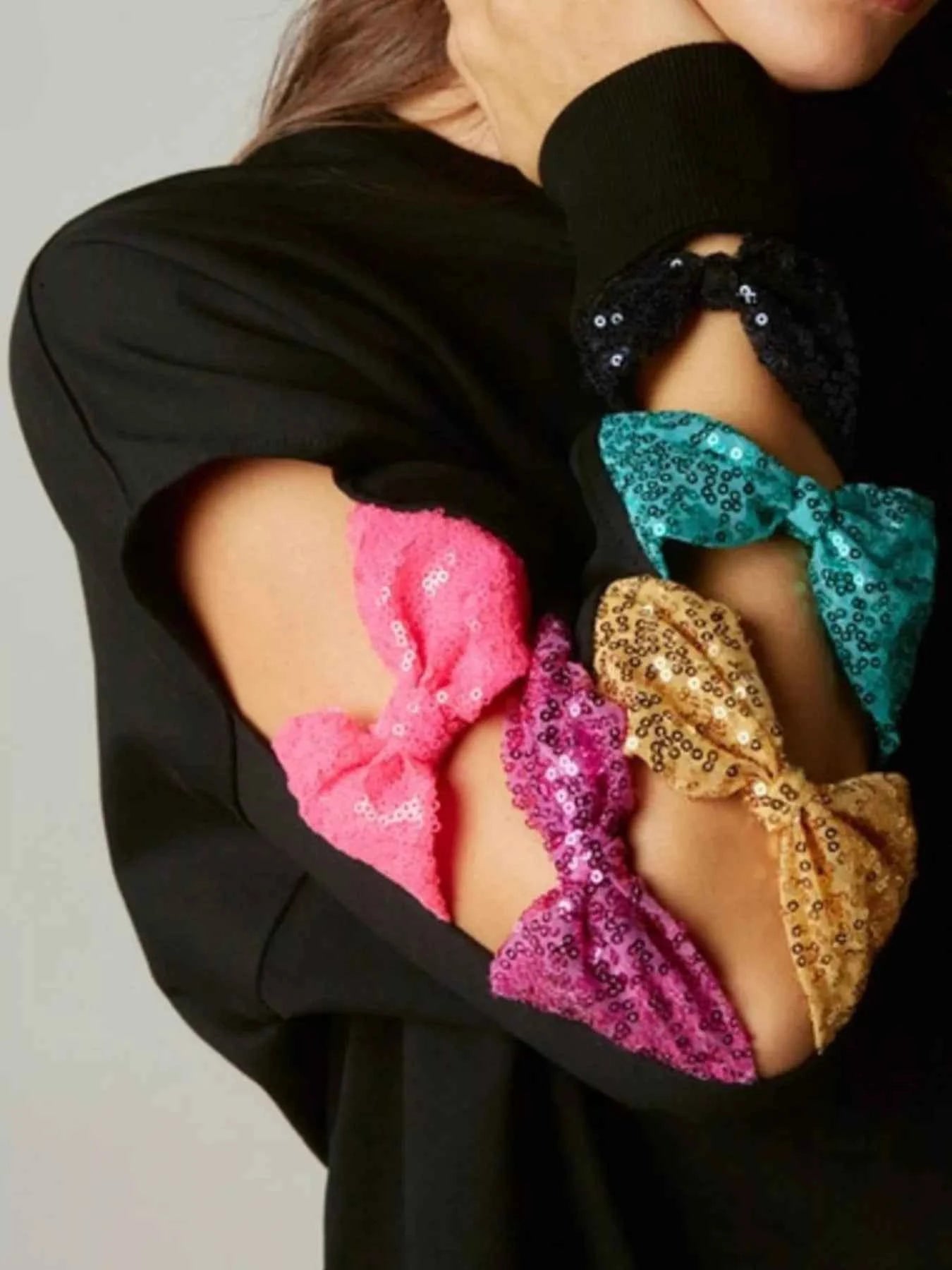 Sequin Bow Cutout Round Neck Sweatshirt f6b230c3-c90a-4b4e-b5f4-3c7a65717128-Max-Origin